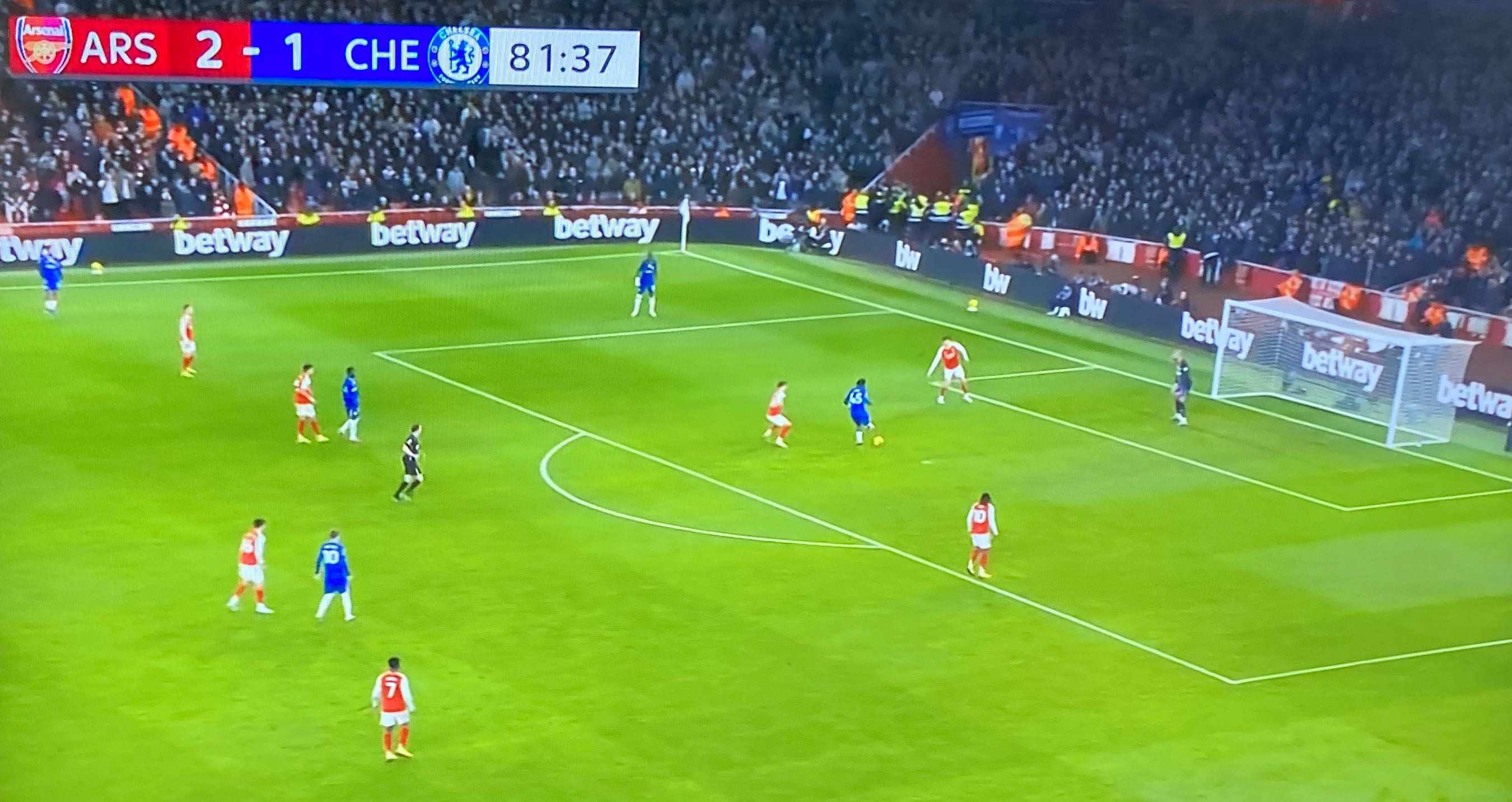 photo of a tv set showing a soccer game between chelsea and arsenal cropped to make the score bug prominent