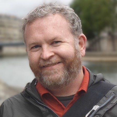 Photo of John Phillips on the banks of the Seine in Paris